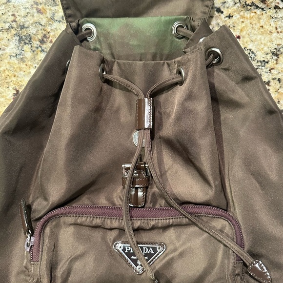 Prada backpack. Pre loved. Brown in color. Pockets inside and outside. - Picture 2 of 12